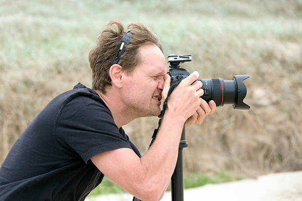 istock Profesional photographer with DSLR camera shooting outdoor 500481838