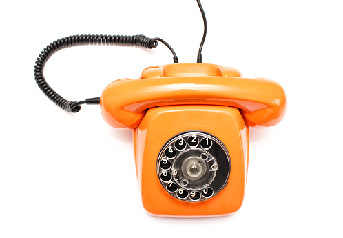 Orange retro telephone isolated on white background. View from above.