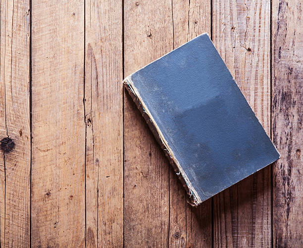 istock Vintage book on old wooden table. 500485954