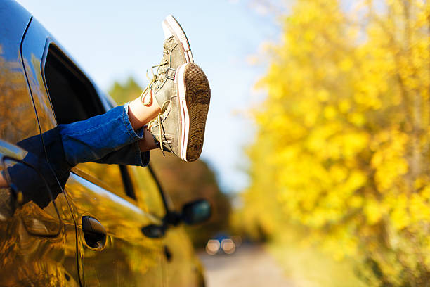 istock boy's legs in sneakers in the window car 500487624