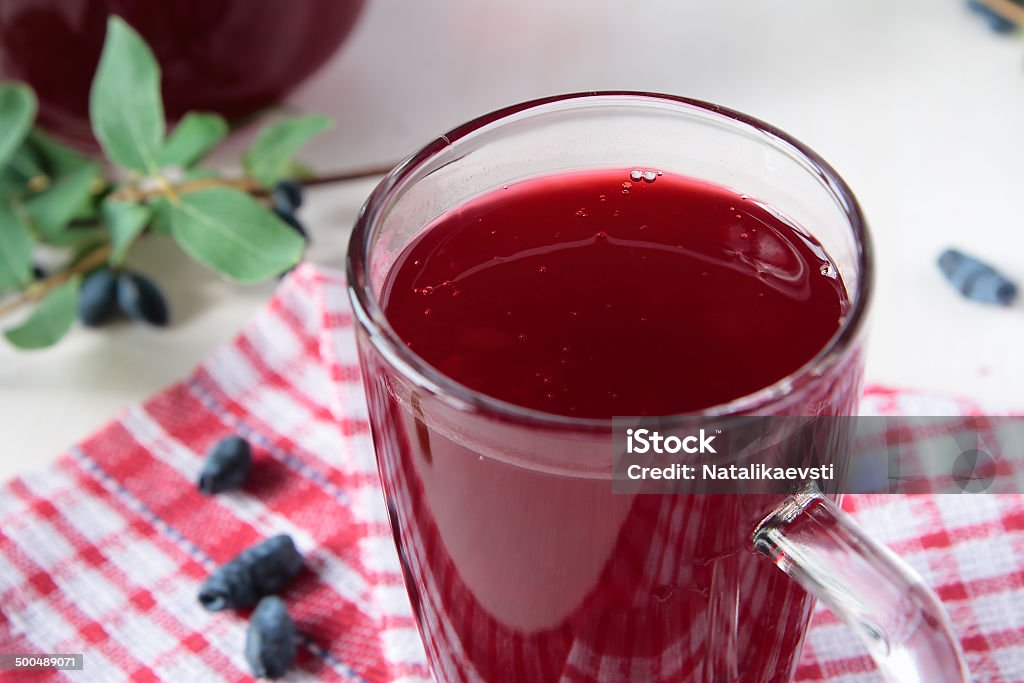 Kissel of honeysuckle in glass Kissel of honeysuckle berries in a glass and a jug Berry Fruit Stock Photo