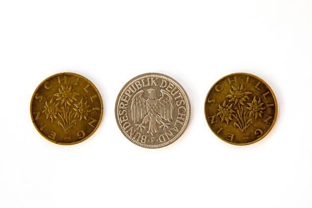 istock Three obsolete coins, Austrian schillings and Deutsche Mark 500489220