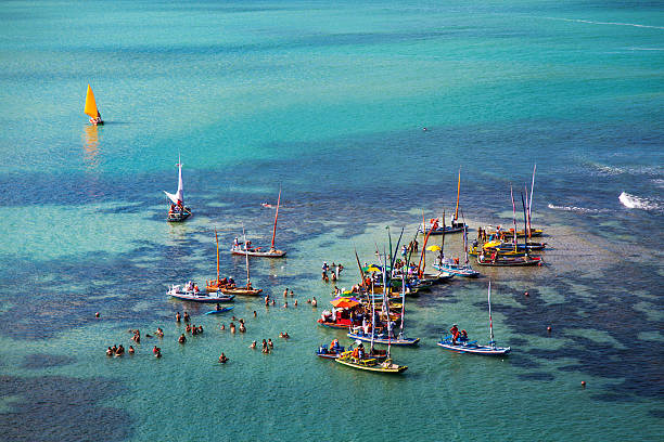 Sailing rafts and sunbathers in Maceio stock photo
