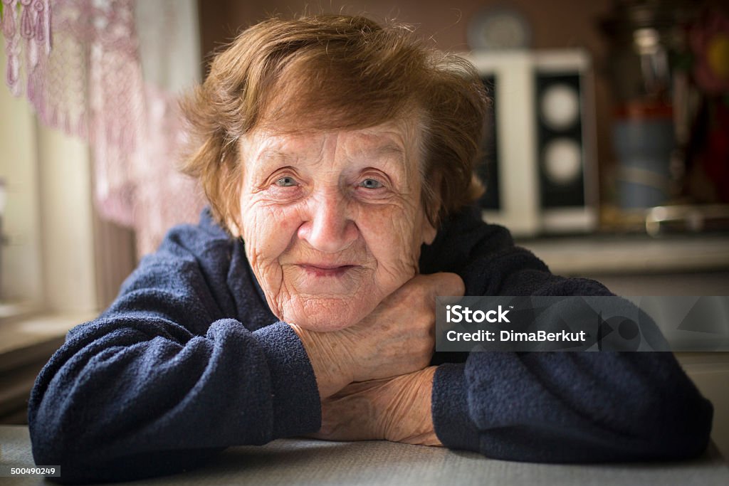 Close-up portrait of an elderly woman in her home. Adult Stock Photo