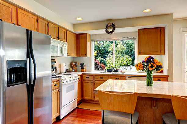 istock Cozy kitchen interior with island and window 500490535