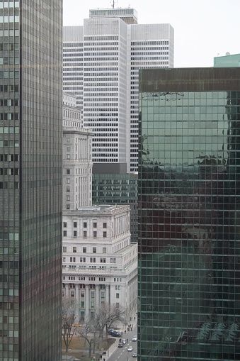 A view of some buildings on the Rene Levesque street in Downtown Montreal with the two famous landmarks Place Ville Marie and Sunlife Building in the background.