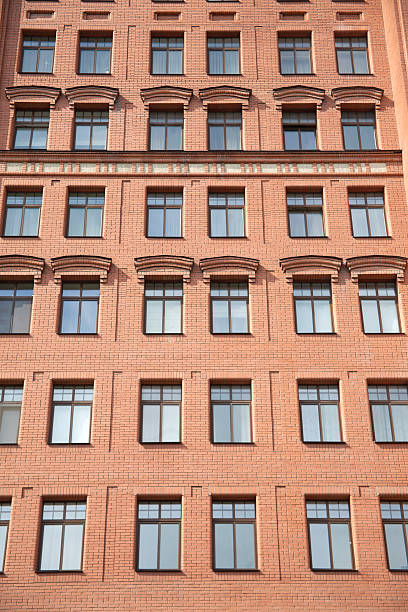 istock Front view of brick wall contemporary apartment building with windows 500491735