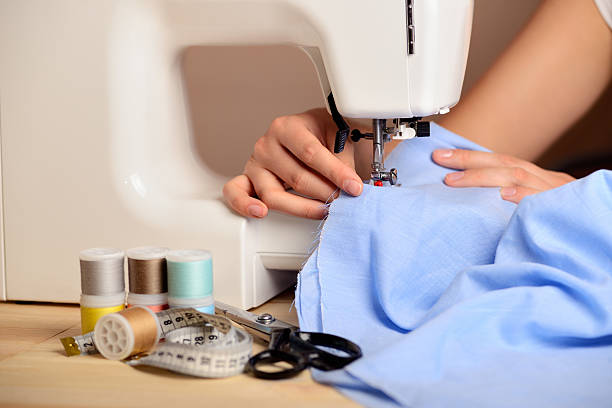 istock Close-up female hands sewing fabric on sewing machine 500493005