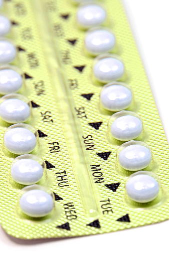 Contraceptive Pill with English Instructions closed-up on white background.
