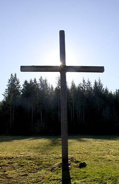 istock Sun Sparkling Behind A Christian Cross 500494004