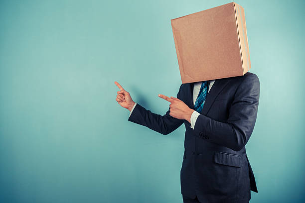 istock Businessman with box on head is pointing 500494857