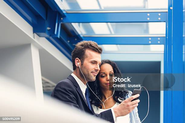 Listening To Music Together Stock Photo - Download Image Now - Airport, Business, Headphones