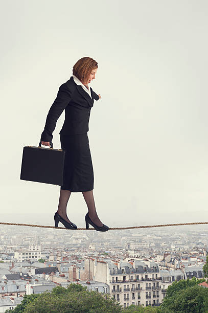 istock businesswoman walking a tightrope 500495781