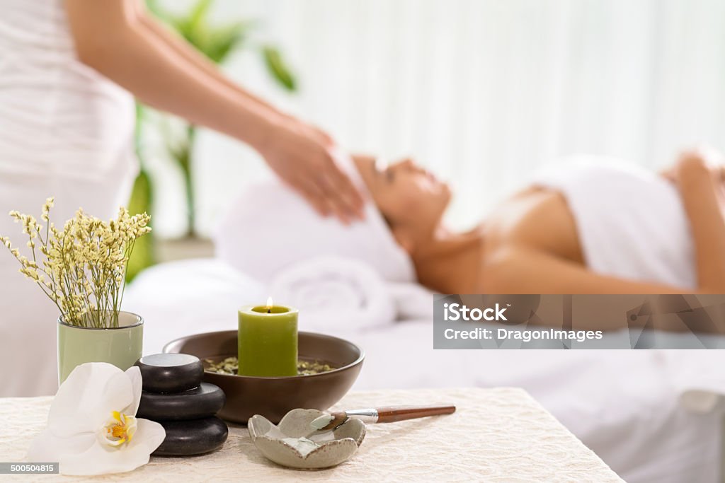 Spa accessories Spa accessories and a woman receiving spa treatment in the background Massaging Stock Photo
