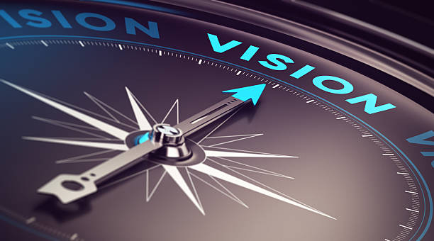 Business Vision Compass with needle pointing the word vision with blur effect plus blue and black tones. Conceptual image for immustration of company or business anticipation or strategy projection stock pictures, royalty-free photos & images