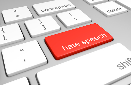 3D render of a computer keyboard with one key labeled for hate speech, representing discriminatory messages that plague online message boards and comment areas.