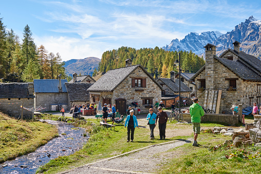 Baceno, Italy: October 11, 2015: tourists enjoying a sunny autumn day at Campriolo mountain village.