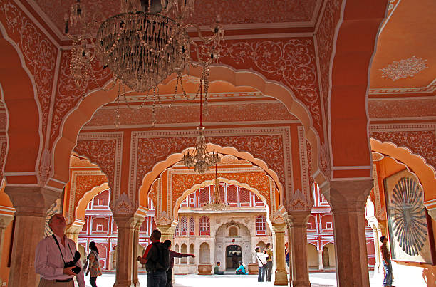 Jaipur, India - March 8, 2011: Visitors marvel at the Diwan-I-Khas in the City Palace in Jaipur, which includes the Chandra Mahal and Mubarak Mahal palaces and other buildings. Built between 1729 and 1732, it was the seat of the Maharaja of Jaipur, the head of the Kachwaha Rajput clan.