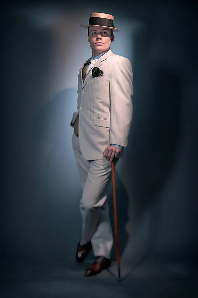 Retro business fashion man wearing white striped suit and hat. Retro classic business fashion man wearing white striped suit and hat. Standing with cane. Studio shot. gangster hat stock pictures, royalty-free photos & images