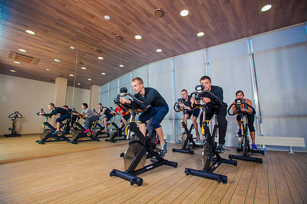 istock Group of gym people on machines, cycling In Class 500506786