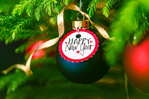 istock Christmas bauble with New Year message on Christmas tree branches 500507416