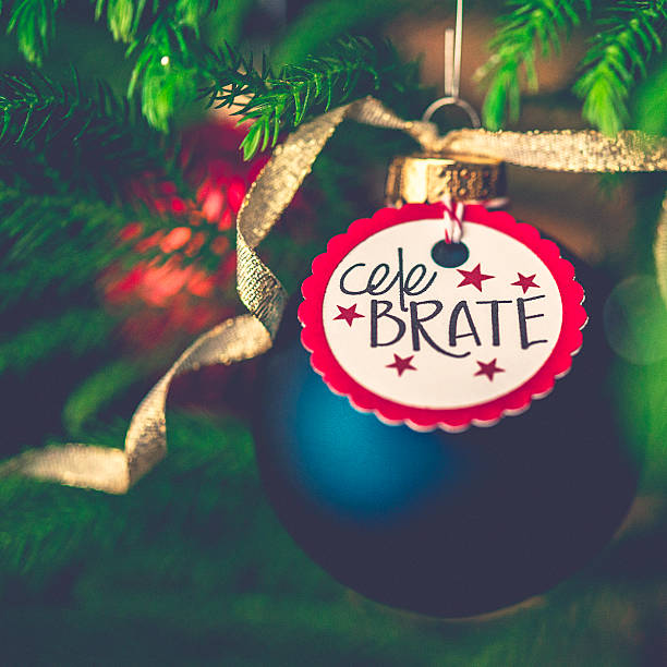 istock Christmas bauble with Celebrate message on Christmas tree branches 500507584