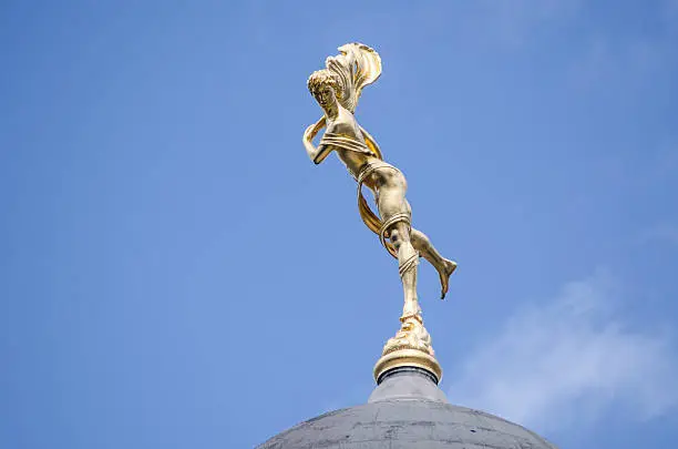 Gilded statue of Ariel - the spirit of the air - on a dome above the Bank of England in the City of London.  Sculpted by Charles Wheeler and on public display since 1937.