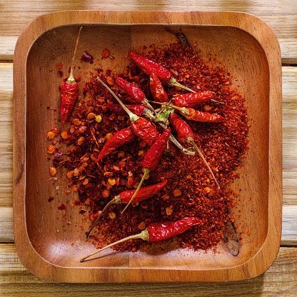 Macro closeup of red chili peppers piled high in a Colombian market