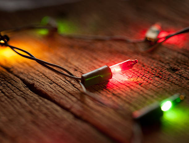 istock christmas light decor on wood background, selective focus 500509866