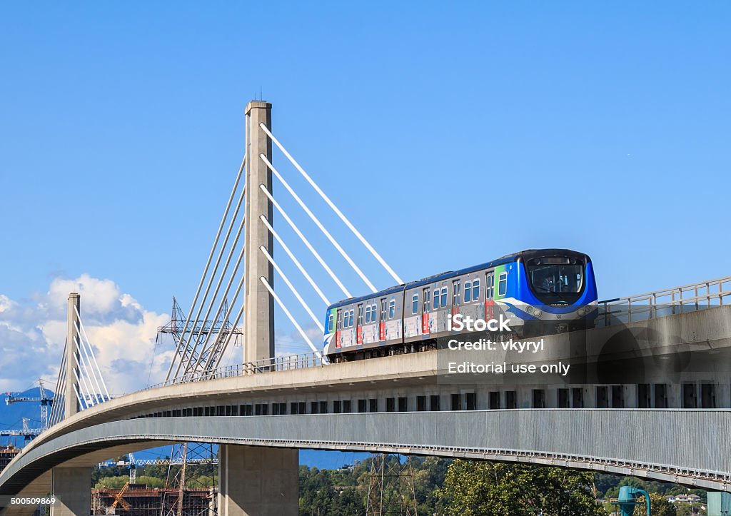 Canada Line Bridge Vancouver, Canada - May 30, 2014: Canada line train passes bridge on May 30, 2014. The Canada Line is Vancouver new rapid transit rail link connecting airport to downtown Vancouver. Train - Vehicle Stock Photo