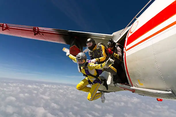 Two girls parachutist jumping out of an airplane.