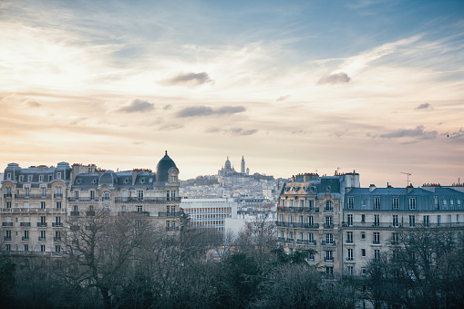 Montmartre Hill and Sacre Coeur in Paris, France seen from Buttes Chaumont Park