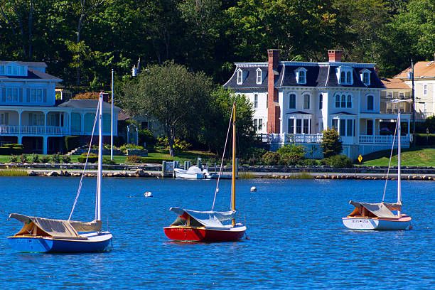 Mystic Curbside Sailboats line up at their moorings on Mystic's main thoroughfare, the Mystic River. connecticut stock pictures, royalty-free photos & images