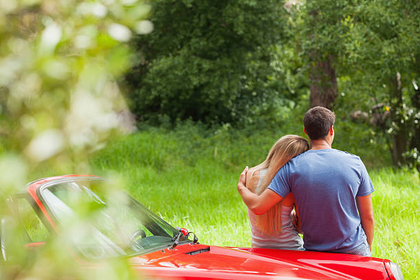 istock Loving couple admiring nature while leaning on their cabriolet 500511499