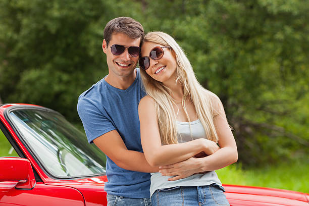 istock Cheerful couple hugging and leaning against cabriolet 500511803