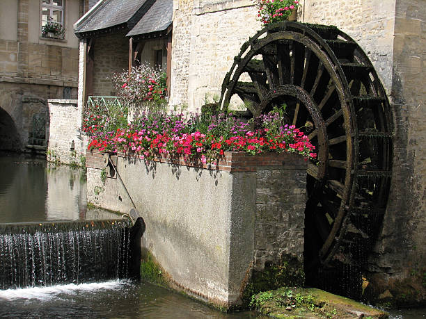 istock French cottage with waterwheel 500513944