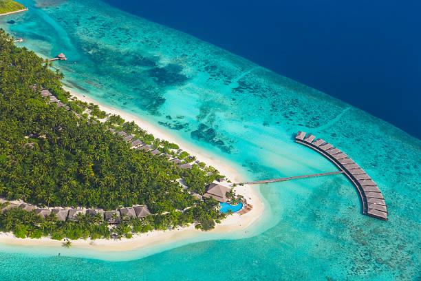 Tropical island at Maldives Tropical island at Maldives - aerial view atoll photos stock pictures, royalty-free photos & images