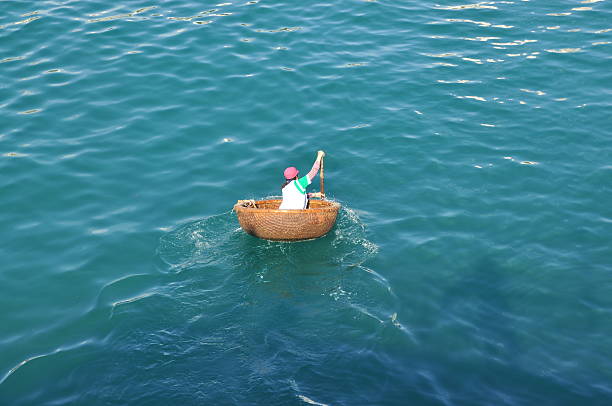 narrow boat with oar and straw hat