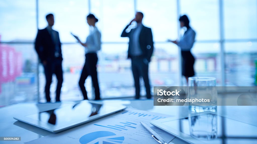 Busy day Business people working in office corridor Four People Stock Photo