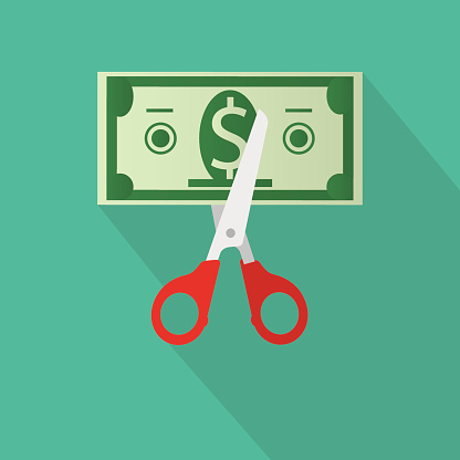 Scissors cutting money bill. vector illustration in flat design on green background with long shadow