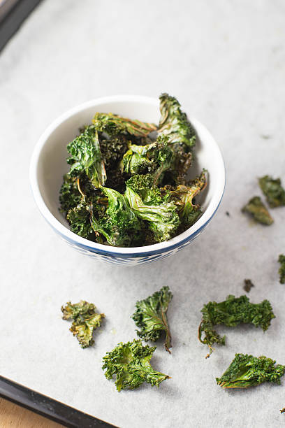 istock Homemade curly kale chips in small bowl. Selective focus 500515372