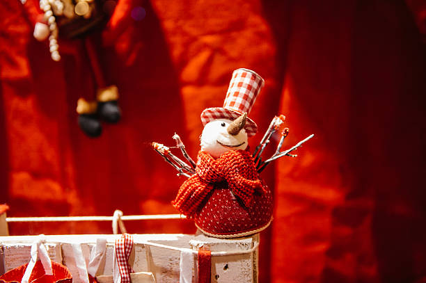 Busy Christmas Market Christkindlmarkt in the city of Strasbourg, Alsace region,  France with snowman toy in windows shop