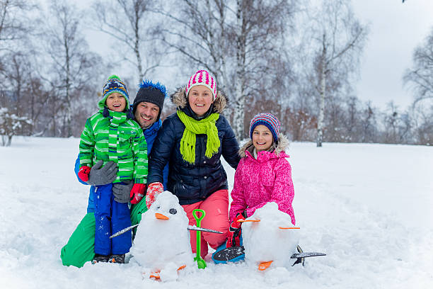 istock Family with a snowman 500516956