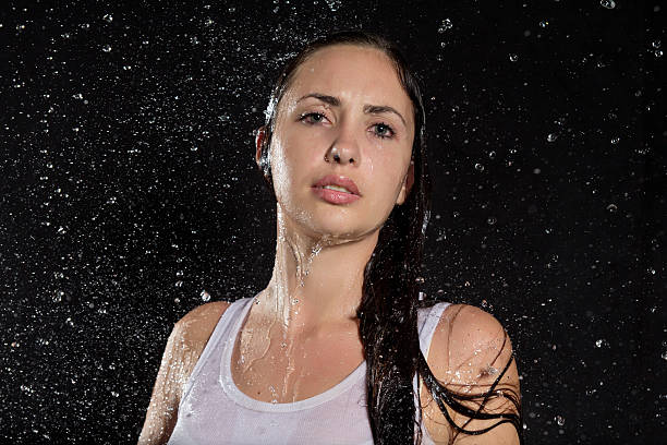 istock Beautiful wet girl in white under rain 500524947