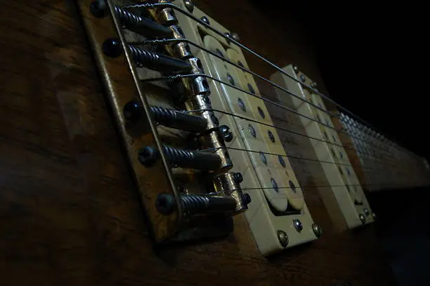 Close up of guitar bridge,strings and pickup