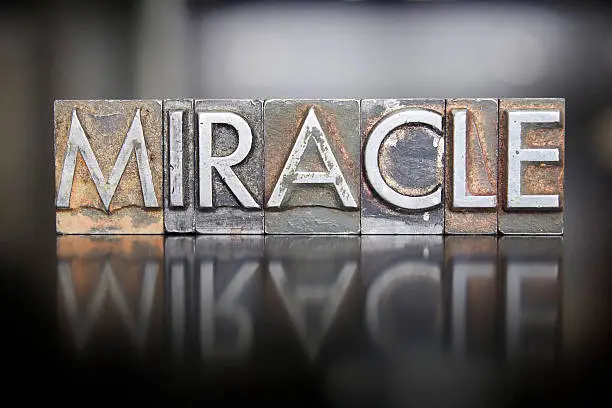 The word MIRACLE written in vintage lead letterpress type