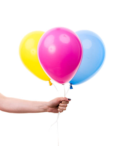istock Colorful Balloons held by Female Hand. On White Background 500526639