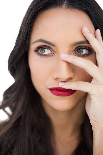 istock Thoughtful dark haired woman with red lips hiding her face 500527161