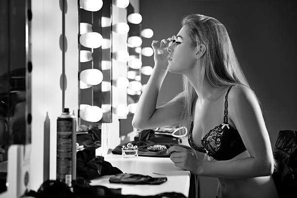 istock woman wearing lingerie posing next to mirror 500527309