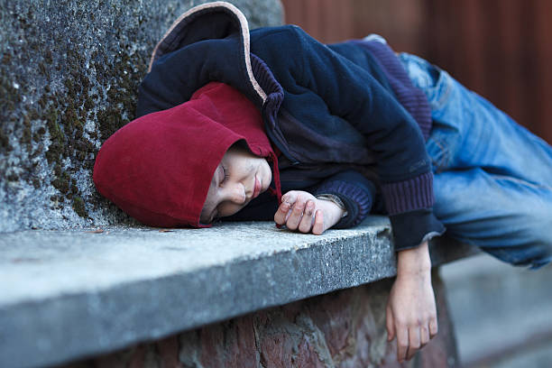 istock young homeless boy sleeping on the street 500534492